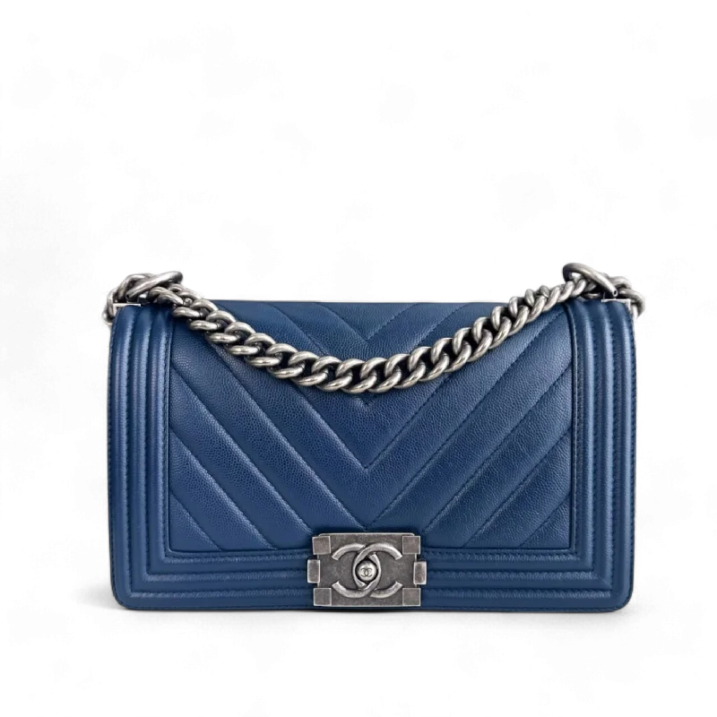 Chanel bags with iconic stitching detailsChanel Boy Medium - Caviar Chevron Dark Blue Ruthenium Silver Hardware Series 24